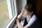 young woman looking out the window